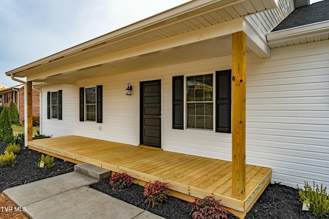 wooden terrace featuring covered porch