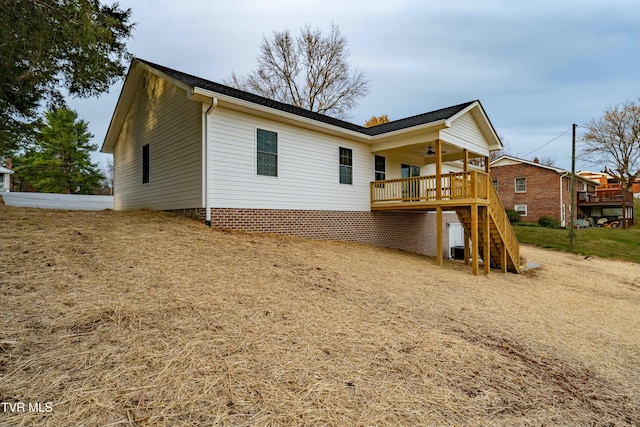 back of property featuring ceiling fan