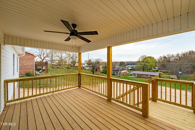 wooden deck featuring ceiling fan and a yard