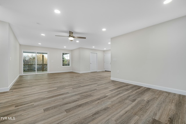 unfurnished living room featuring ceiling fan and light wood-type flooring