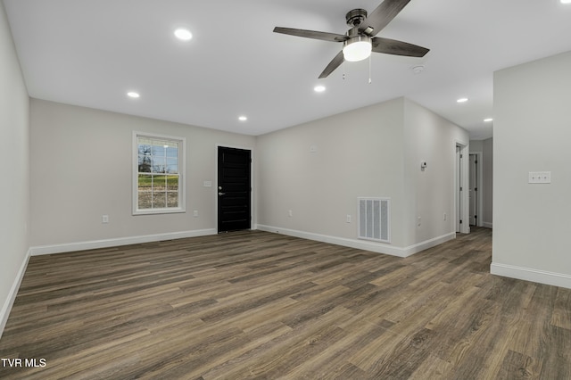 empty room with dark hardwood / wood-style floors and ceiling fan