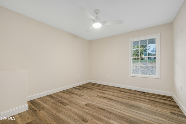 spare room featuring hardwood / wood-style floors and ceiling fan