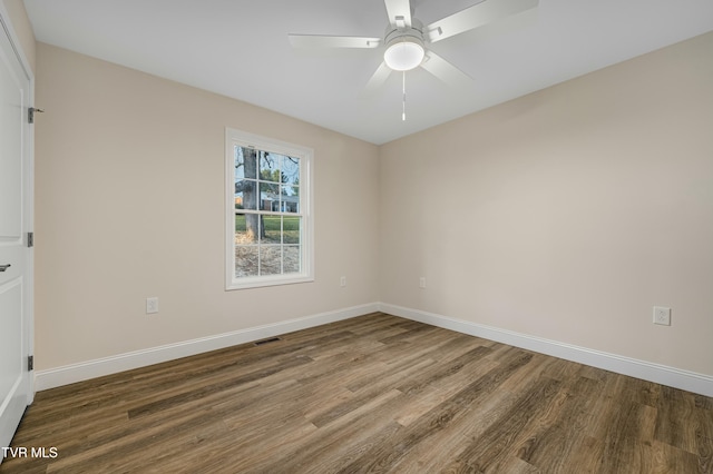 unfurnished room featuring ceiling fan and dark wood-type flooring