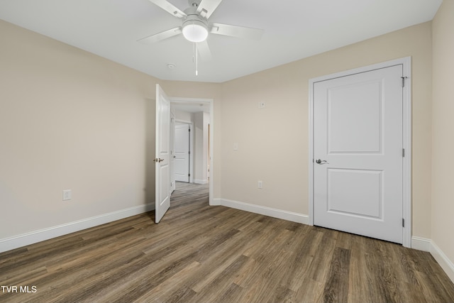 unfurnished bedroom featuring ceiling fan and dark hardwood / wood-style floors