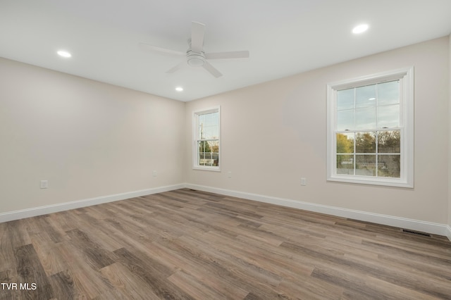 unfurnished room featuring ceiling fan and light hardwood / wood-style floors