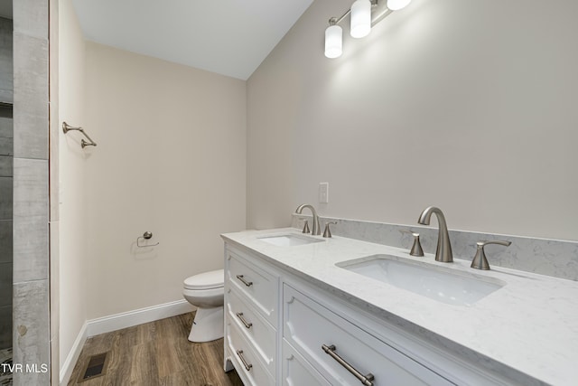 bathroom featuring hardwood / wood-style floors, vanity, and toilet