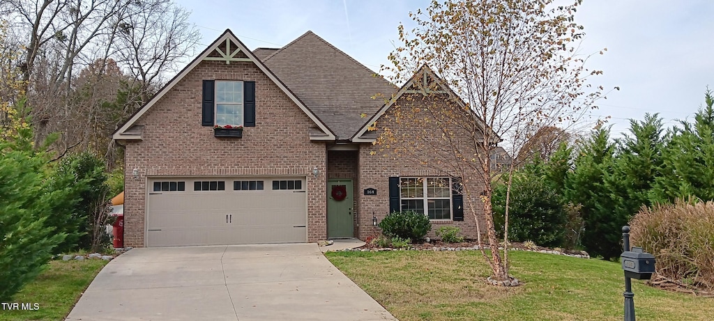 view of front of property with a front yard and a garage