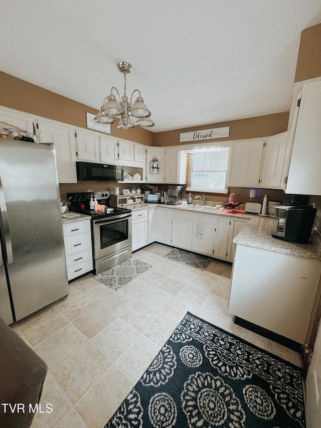 kitchen with a notable chandelier, white cabinetry, hanging light fixtures, and appliances with stainless steel finishes