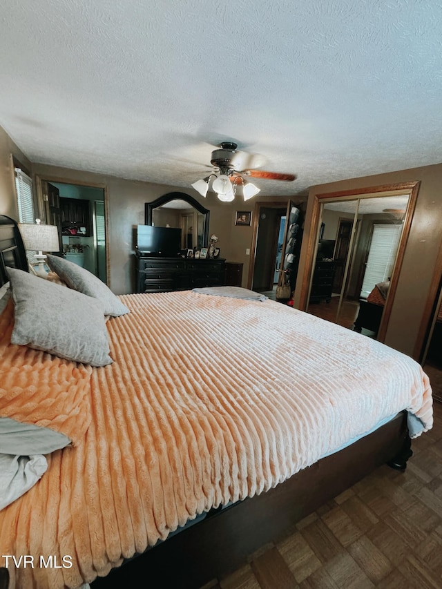 bedroom featuring a textured ceiling, a closet, and ceiling fan