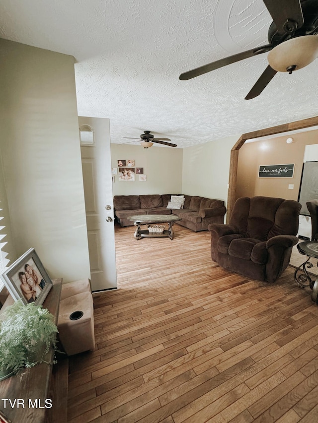 living room with hardwood / wood-style floors and a textured ceiling