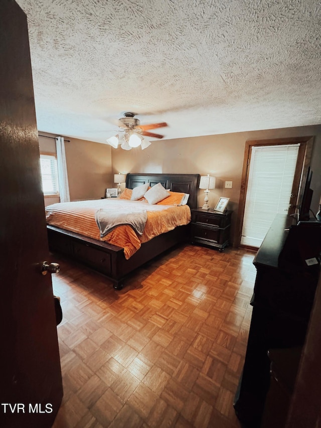 bedroom featuring a textured ceiling and ceiling fan