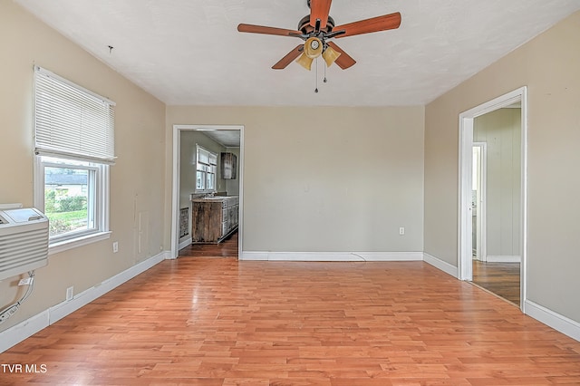 empty room with light hardwood / wood-style flooring and ceiling fan