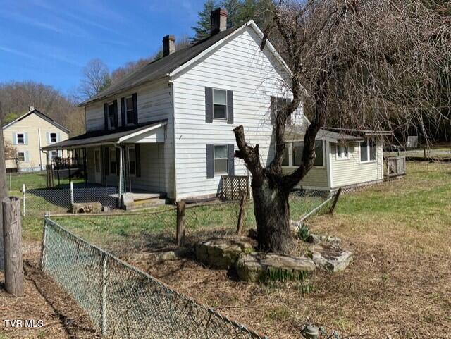 view of side of property with a yard