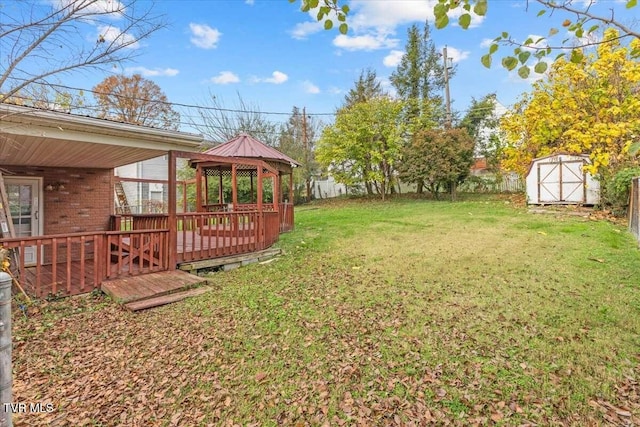 view of yard with a gazebo, a shed, and a deck