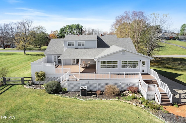 back of house with a deck and a yard