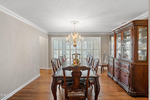 dining area featuring an inviting chandelier, a wealth of natural light, and light hardwood / wood-style flooring