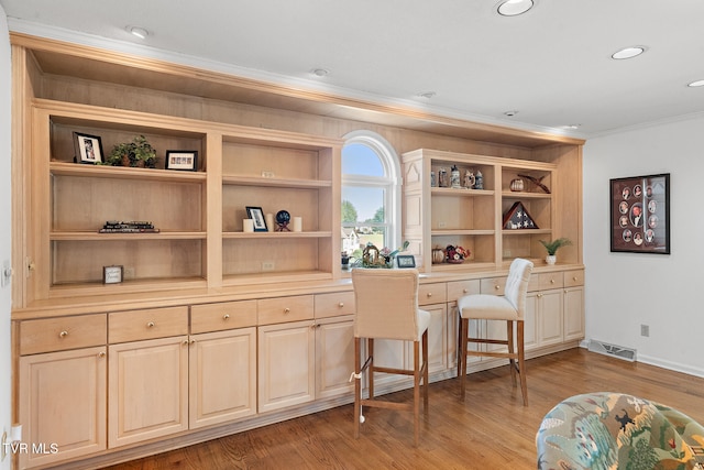 office with crown molding and light hardwood / wood-style flooring