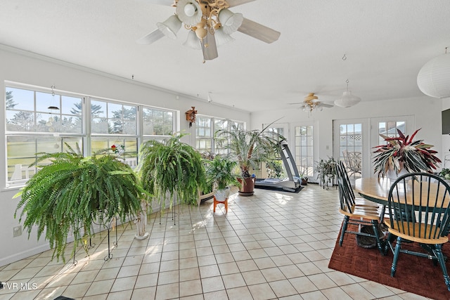 sunroom / solarium featuring french doors, plenty of natural light, and ceiling fan