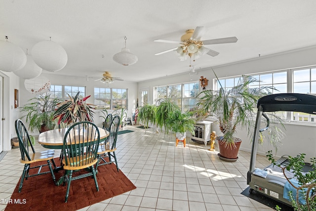 sunroom / solarium featuring ceiling fan