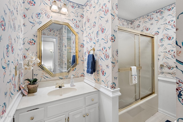 bathroom with tile patterned flooring, vanity, enclosed tub / shower combo, and a textured ceiling