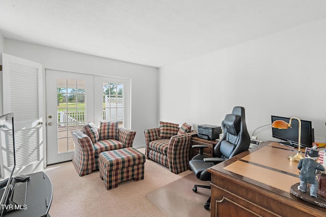 carpeted home office with french doors