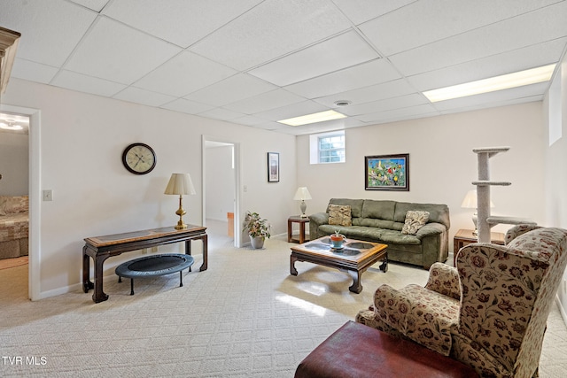 carpeted living room featuring a paneled ceiling