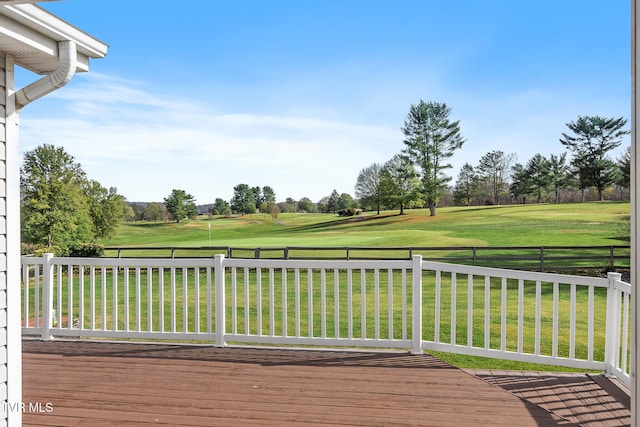 wooden terrace featuring a lawn