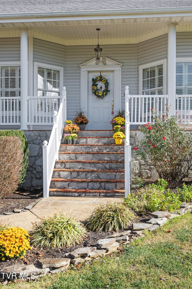 entrance to property featuring a porch