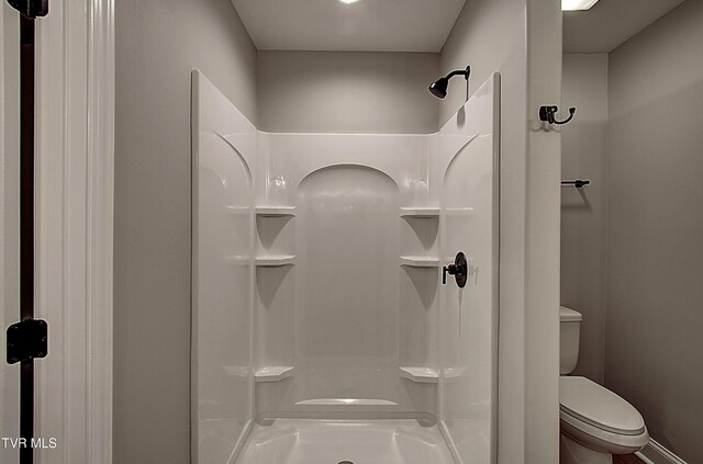 bathroom with a shower and toilet