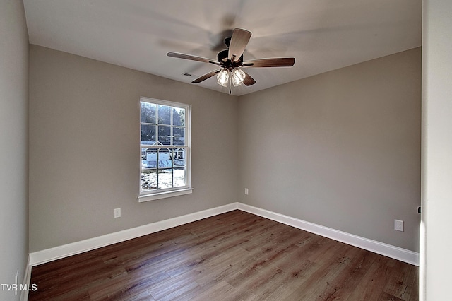 spare room with ceiling fan and wood-type flooring