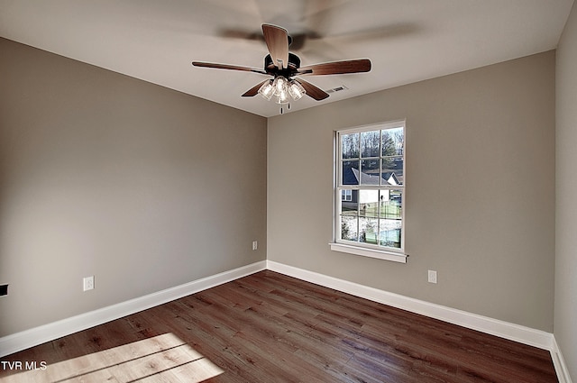 spare room with ceiling fan and dark hardwood / wood-style floors