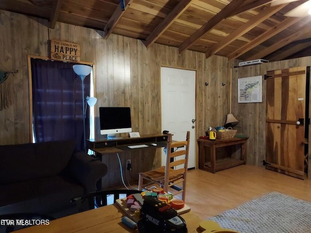 office space with hardwood / wood-style flooring, lofted ceiling with beams, wooden ceiling, and wooden walls