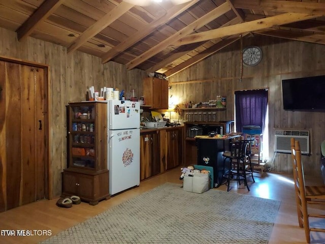 kitchen featuring lofted ceiling with beams, white refrigerator, light wood-type flooring, and wooden walls