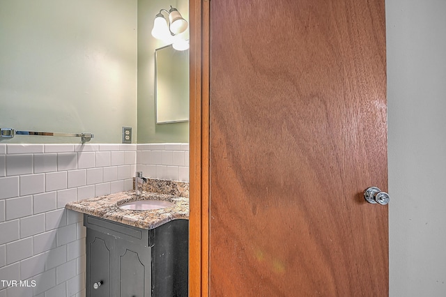 bathroom with vanity and tasteful backsplash