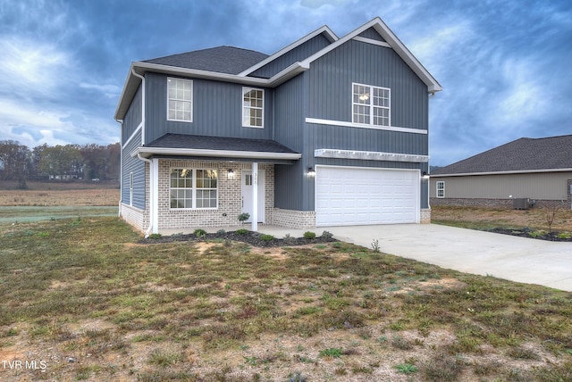 view of front of property featuring a front lawn, cooling unit, and a garage