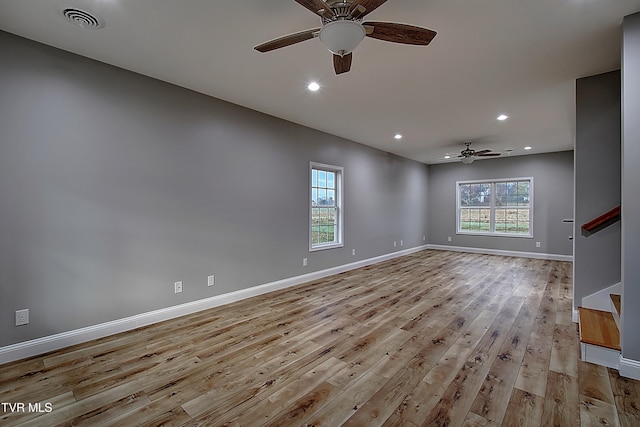 unfurnished room with ceiling fan and light wood-type flooring