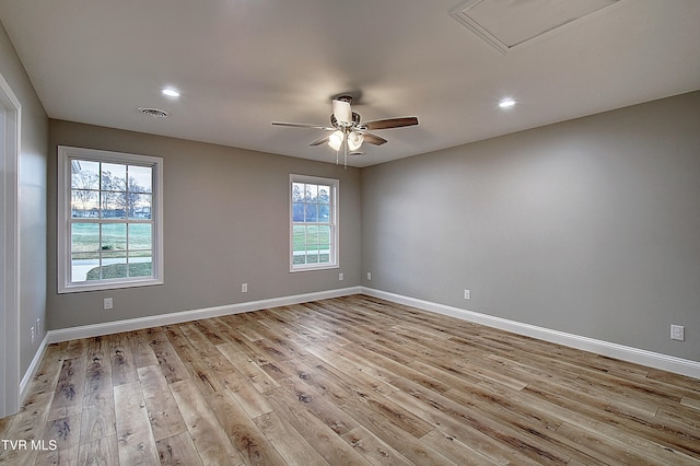 spare room featuring ceiling fan, plenty of natural light, and light hardwood / wood-style flooring