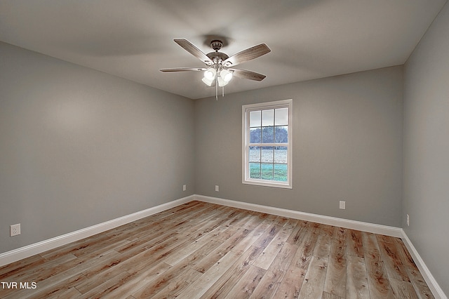 empty room with light hardwood / wood-style flooring and ceiling fan