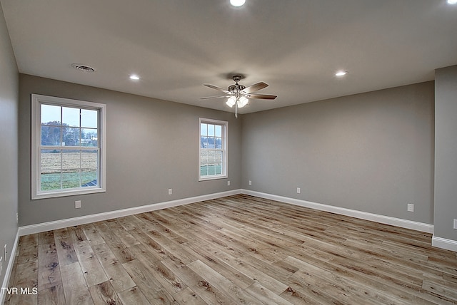 unfurnished room featuring light hardwood / wood-style floors and plenty of natural light