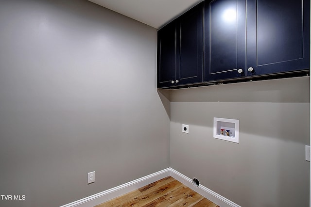 clothes washing area featuring hookup for a washing machine, hardwood / wood-style floors, cabinets, and hookup for an electric dryer