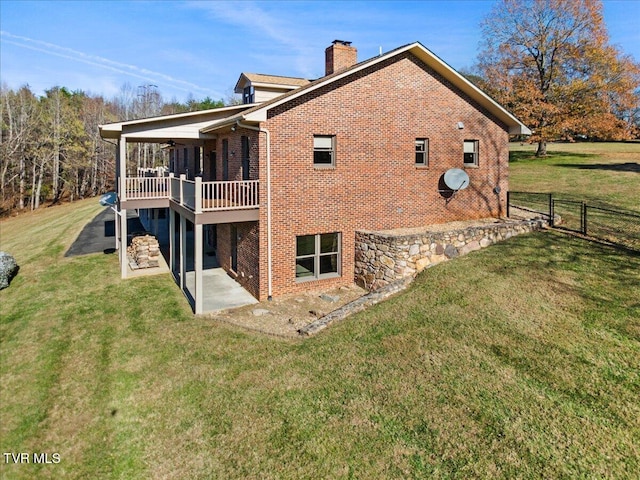 back of property featuring ceiling fan, a yard, a patio, and a wooden deck