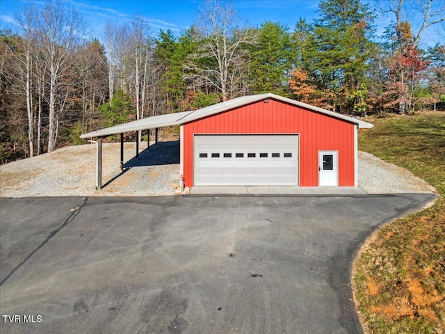 garage with a carport and a yard