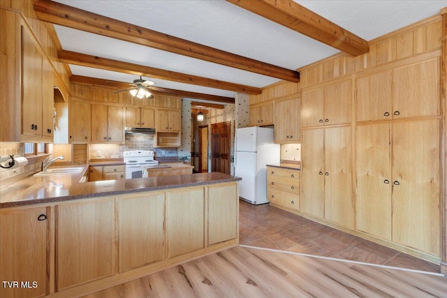 kitchen featuring kitchen peninsula, white appliances, light hardwood / wood-style floors, and beamed ceiling