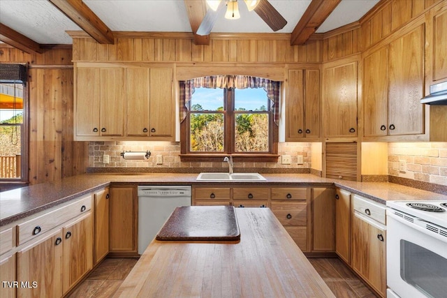 kitchen featuring beam ceiling, white appliances, plenty of natural light, and sink