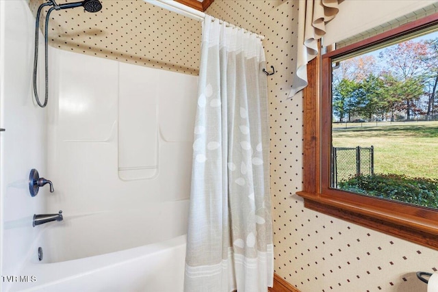 bathroom featuring shower / tub combo with curtain and a healthy amount of sunlight