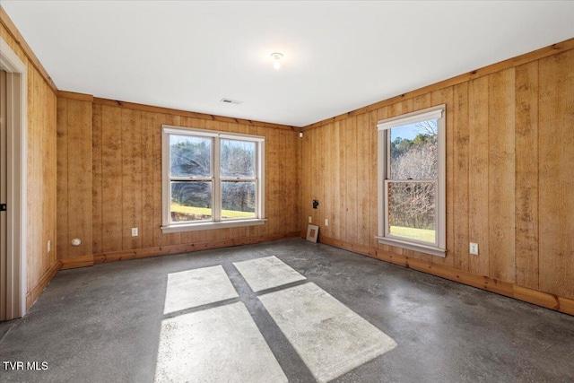 spare room featuring wood walls