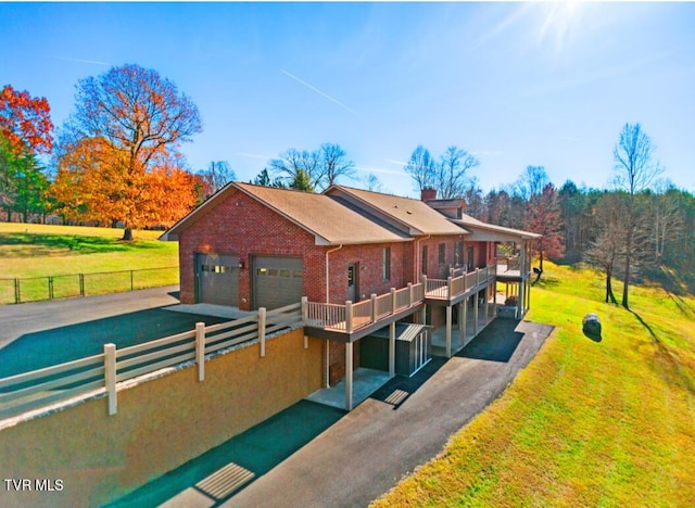 view of front of property with a balcony and a front yard