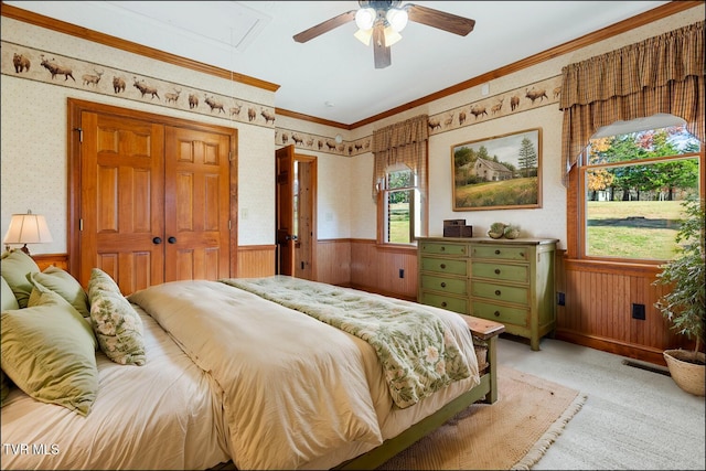 bedroom with visible vents, ornamental molding, wainscoting, and wallpapered walls