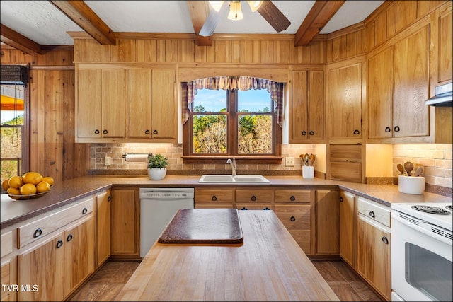 kitchen featuring butcher block countertops, backsplash, white appliances, and a sink