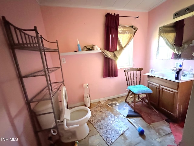 bathroom with vanity, ornamental molding, and toilet